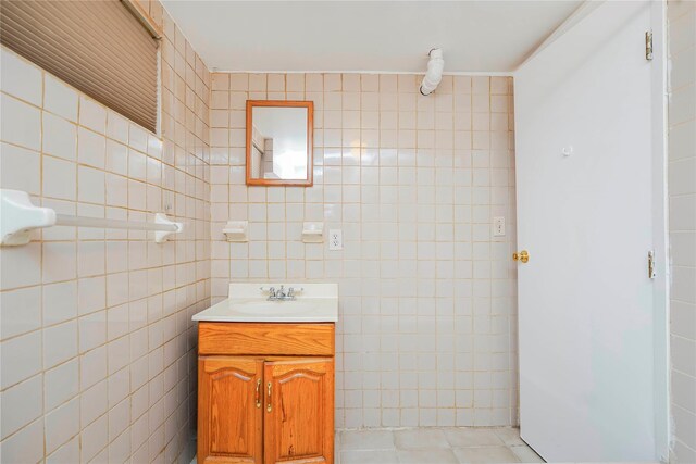 bathroom with tile patterned flooring, tile walls, and vanity