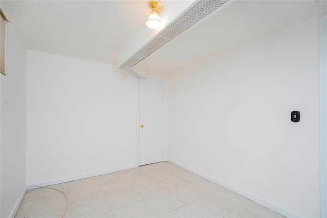 spare room with baseboards