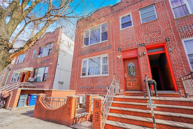 townhome / multi-family property with brick siding