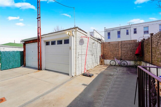 detached garage featuring fence