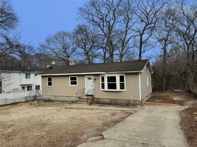 view of front of property with fence and a shingled roof