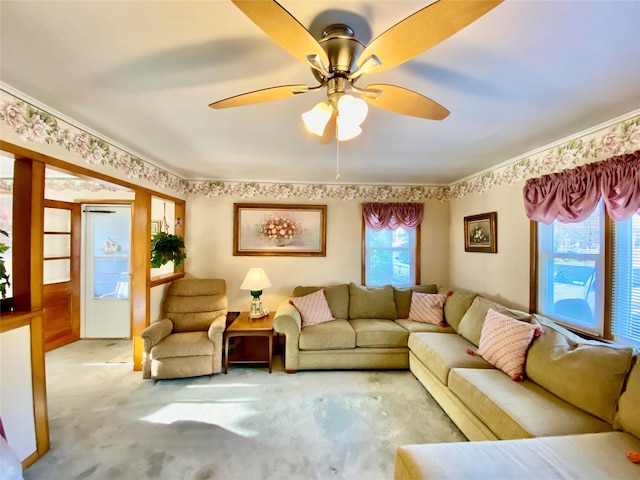 living area featuring carpet and a ceiling fan