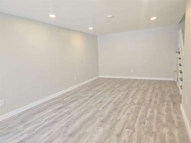 unfurnished room featuring recessed lighting, baseboards, and light wood-style floors