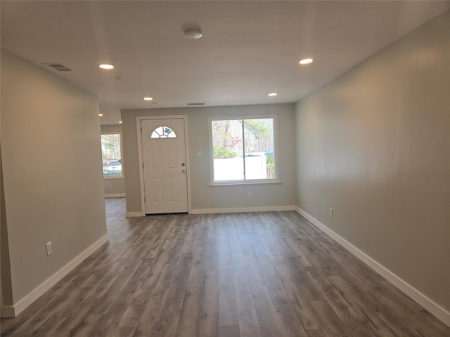 foyer entrance with dark wood-style floors, visible vents, recessed lighting, and baseboards