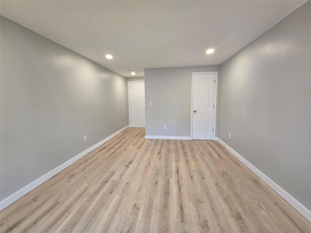 unfurnished room featuring recessed lighting, baseboards, and light wood finished floors