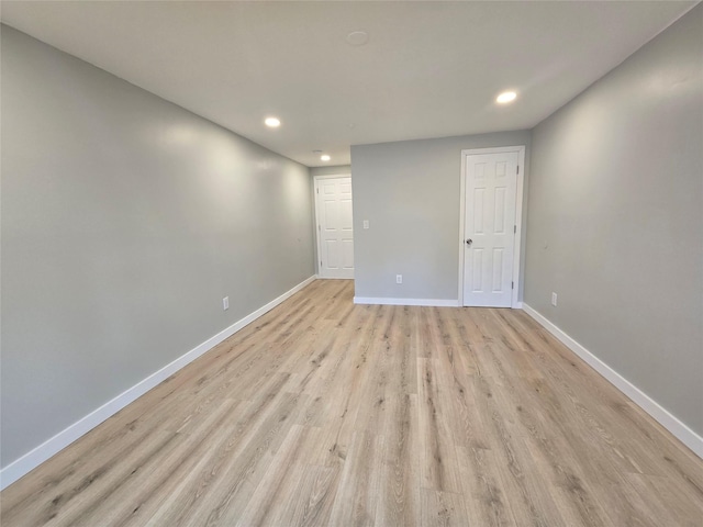 empty room with recessed lighting, baseboards, and light wood-type flooring