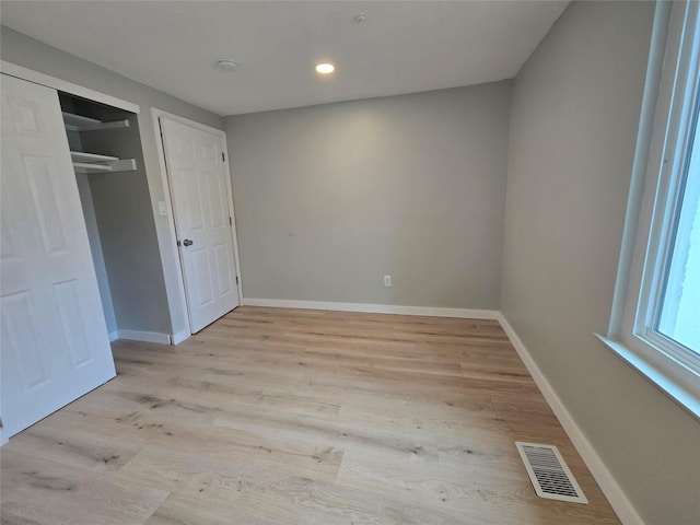 unfurnished bedroom featuring recessed lighting, visible vents, baseboards, and light wood-style floors