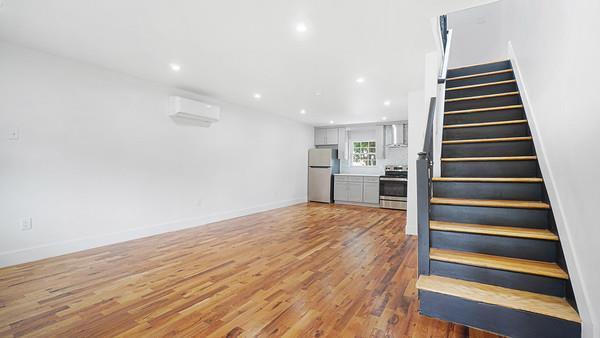 stairs with recessed lighting, baseboards, wood finished floors, and a wall mounted AC