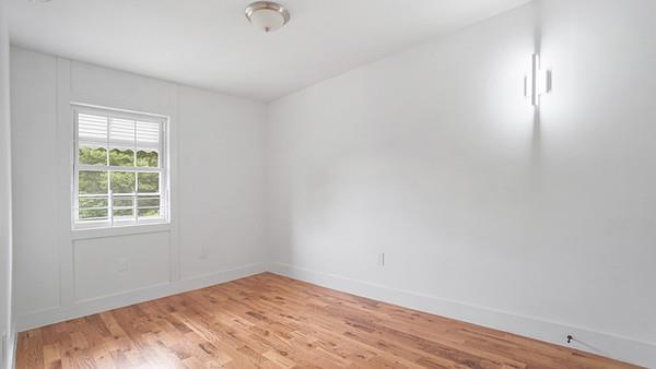 empty room featuring baseboards and light wood finished floors