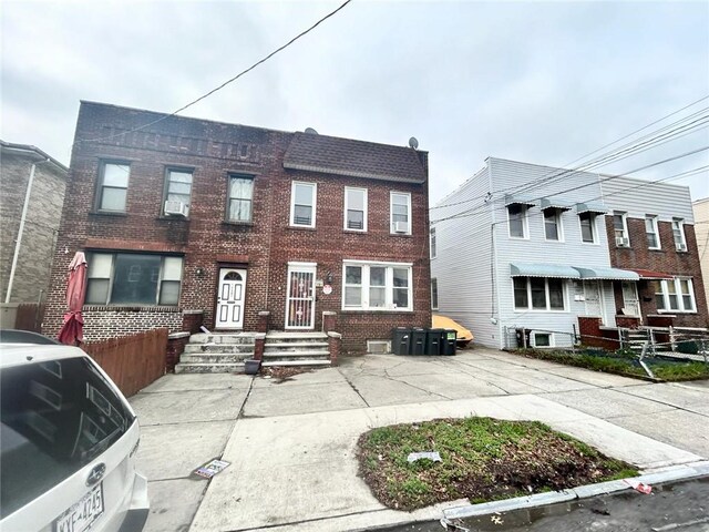 multi unit property featuring cooling unit and brick siding