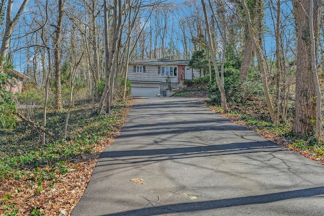 view of front of home with aphalt driveway and an attached garage