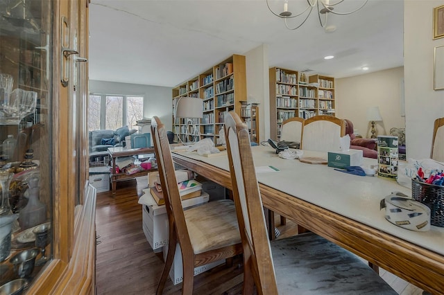 dining area with dark wood finished floors, a notable chandelier, and recessed lighting