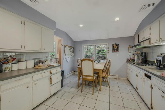 kitchen with visible vents, tasteful backsplash, light tile patterned floors, a baseboard radiator, and lofted ceiling