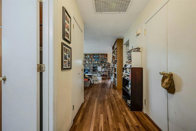 hall featuring dark wood finished floors and visible vents