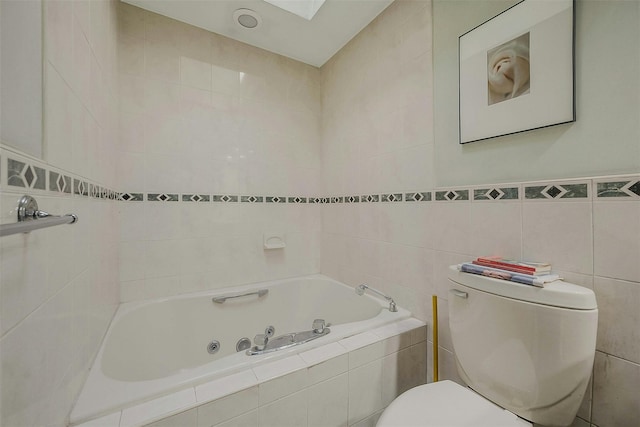 full bath featuring tile walls, toilet, and a tub with jets