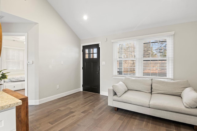 foyer featuring vaulted ceiling, recessed lighting, wood finished floors, and baseboards