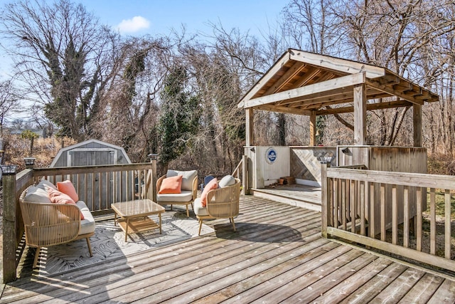 wooden deck featuring a storage unit and an outdoor structure