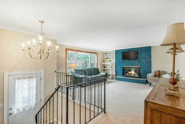 carpeted living room with a wall unit AC, a notable chandelier, a fireplace, and ornamental molding