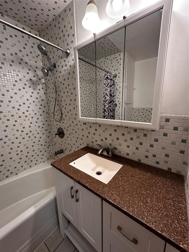 bathroom with decorative backsplash, shower / bath combo with shower curtain, and vanity