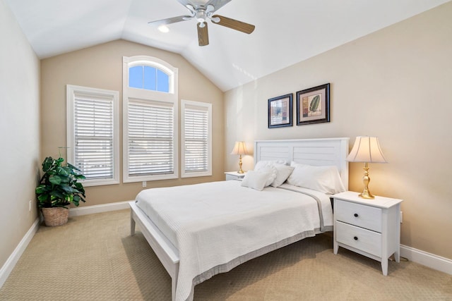 carpeted bedroom with a ceiling fan, baseboards, and vaulted ceiling