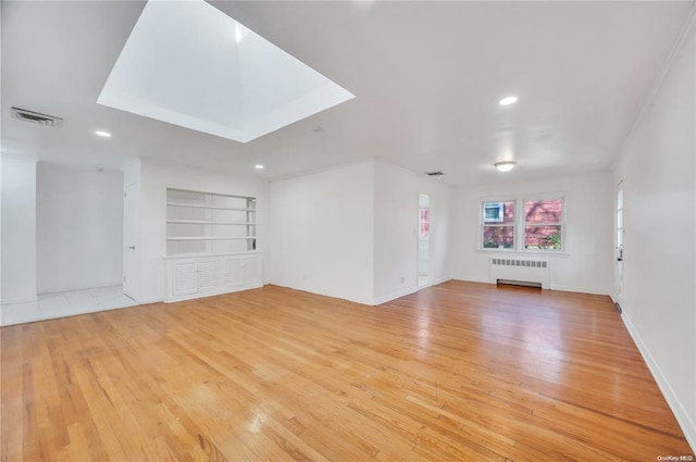 21 Ravine Rd, Great Neck, NY 11023 - unfurnished living room with radiator heating unit, recessed lighting, visible vents, and light wood finished floors
