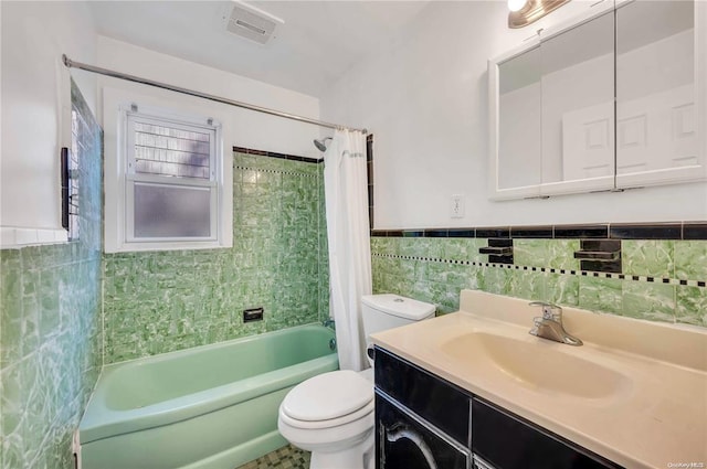 21 Ravine Rd, Great Neck, NY 11023 - full bath with visible vents, toilet, tile walls, shower / tub combo, and vanity
