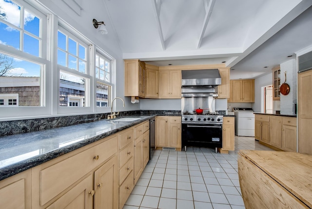 kitchen with light brown cabinets, appliances with stainless steel finishes, and wall chimney range hood