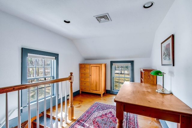 office with recessed lighting, visible vents, light wood-style flooring, and vaulted ceiling