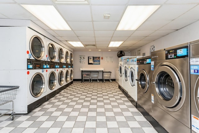 community laundry room featuring light floors and washer and clothes dryer