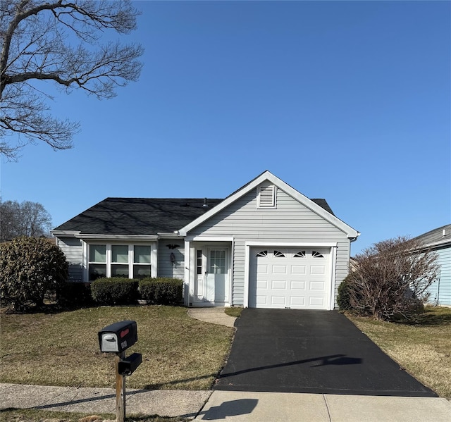 ranch-style home with aphalt driveway, an attached garage, a front lawn, and roof with shingles