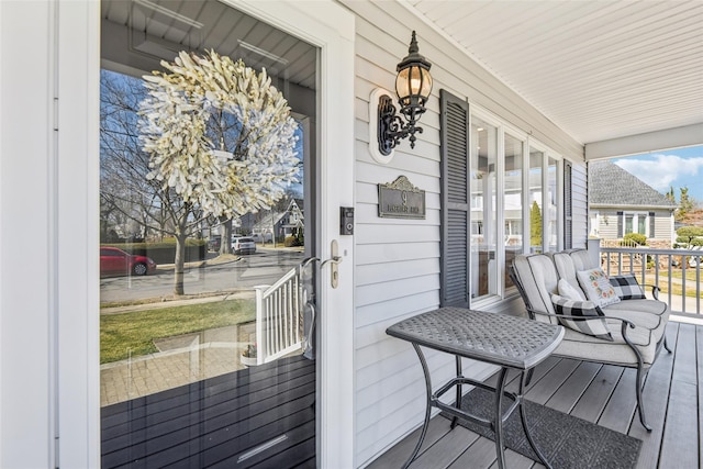 wooden terrace featuring covered porch