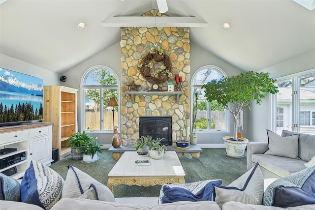 carpeted living area featuring plenty of natural light, high vaulted ceiling, and a fireplace