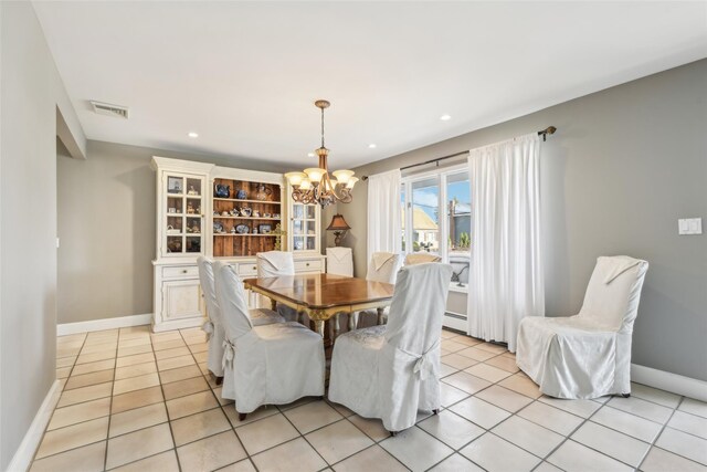 dining space featuring light tile patterned flooring, visible vents, a chandelier, and baseboards