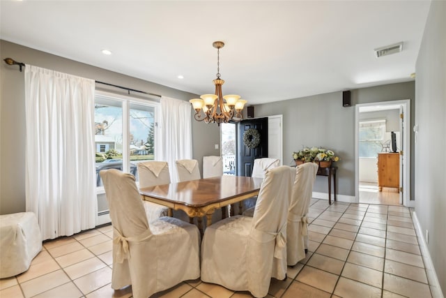 dining space featuring light tile patterned floors, visible vents, and a healthy amount of sunlight