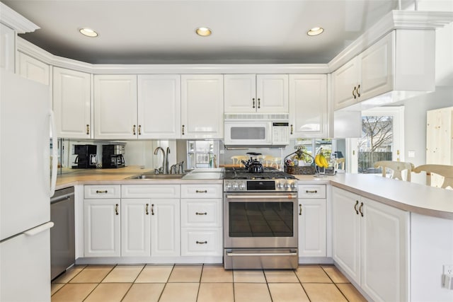 kitchen with a sink, appliances with stainless steel finishes, and white cabinets