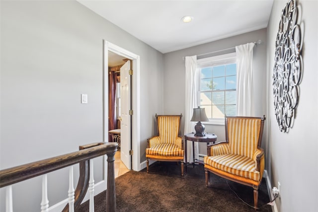 living area with baseboards and carpet floors