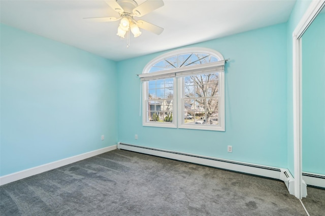 carpeted spare room featuring baseboards, a baseboard heating unit, and a ceiling fan