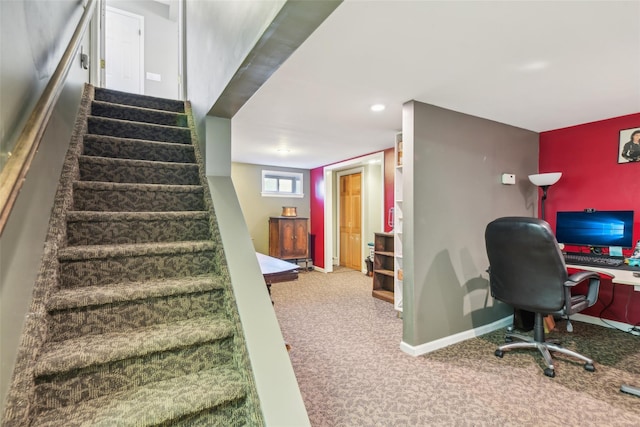 stairway with baseboards and carpet floors