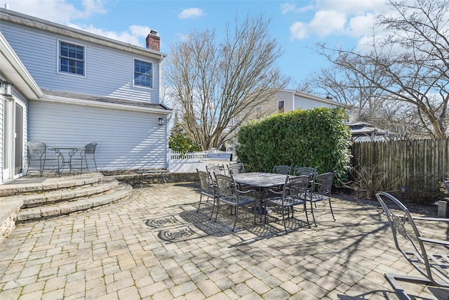 view of patio / terrace featuring outdoor dining space and fence