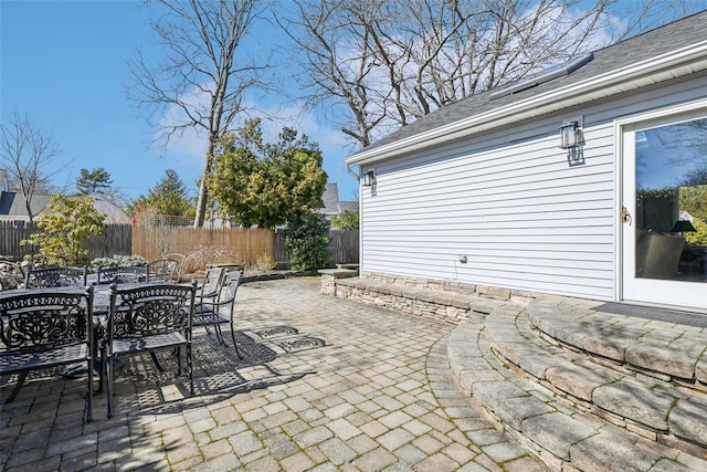 view of patio with outdoor dining area and fence