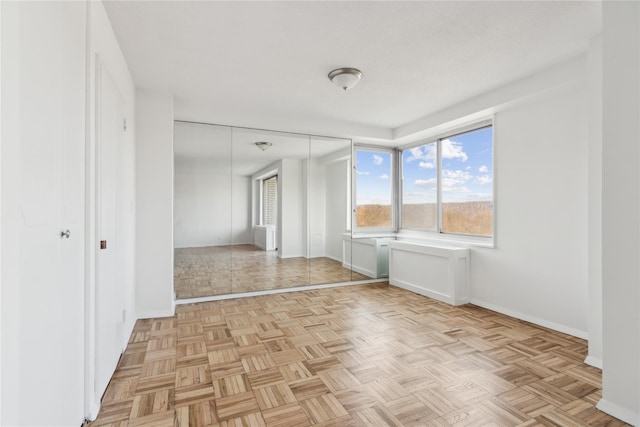 unfurnished room featuring baseboards