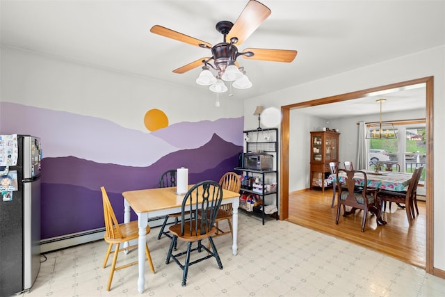 dining area with tile patterned floors, ceiling fan, baseboards, and a baseboard heating unit