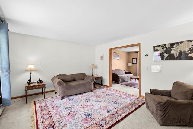 living room with baseboards and light colored carpet