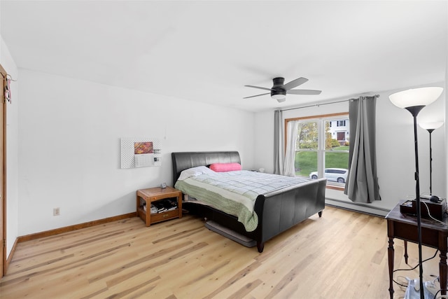 bedroom with baseboards, a ceiling fan, a baseboard heating unit, and light wood finished floors