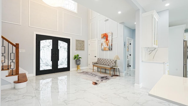 entrance foyer with visible vents, recessed lighting, stairs, french doors, and marble finish floor