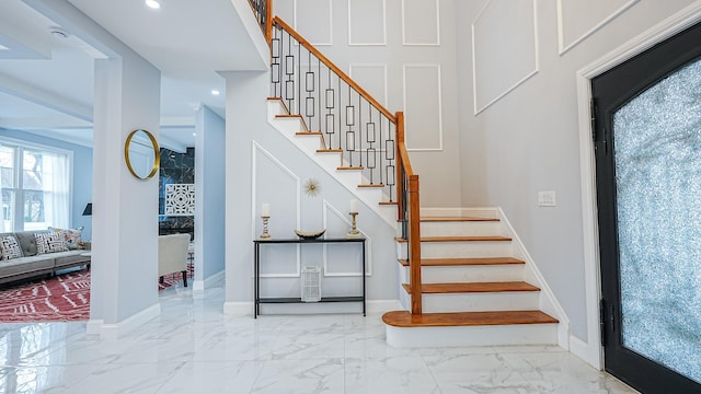 stairway with recessed lighting, marble finish floor, and baseboards