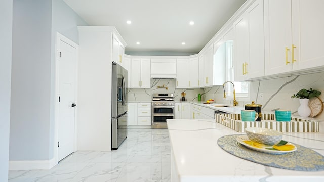 kitchen with recessed lighting, a sink, appliances with stainless steel finishes, marble finish floor, and backsplash