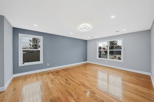 unfurnished room featuring recessed lighting, visible vents, baseboards, and light wood-style floors