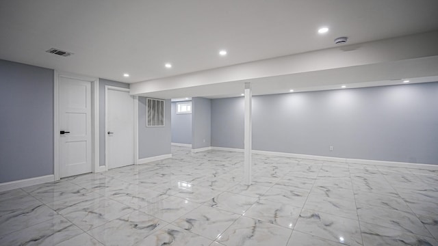 finished below grade area featuring recessed lighting, visible vents, marble finish floor, and baseboards