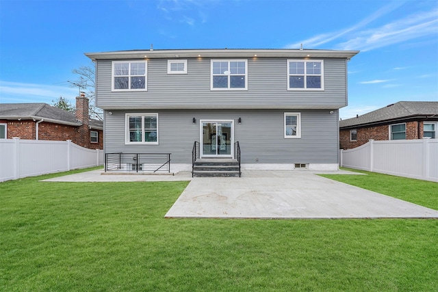 back of property with a fenced backyard, a lawn, and a patio